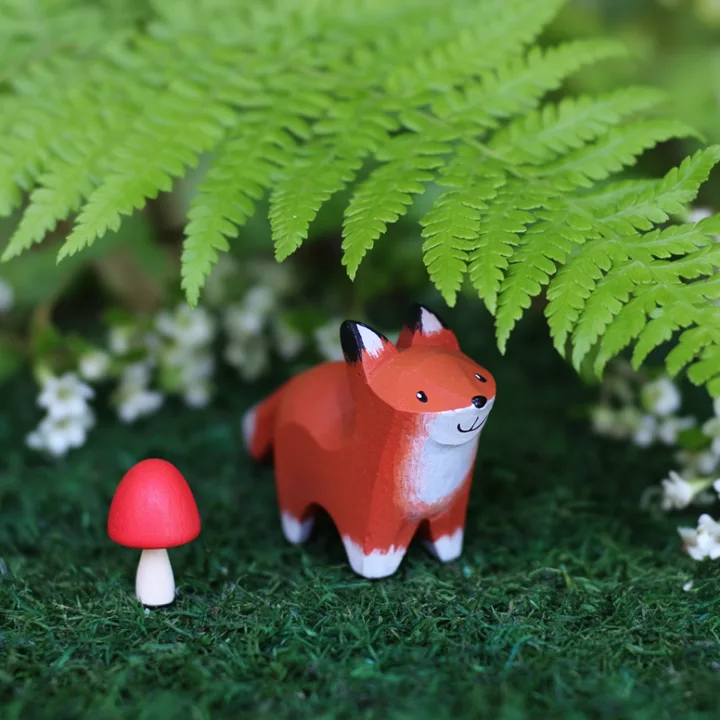 Hand-painted wooden fox under a fern — generated with Krea 2 Large