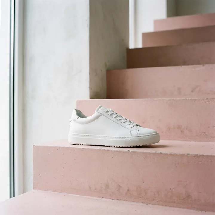 White sneaker on pale pink stairs — generated with Nano Banana 2